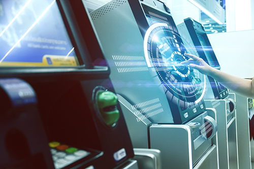 ATM companies in NJ image of 3 ATMs and middle screen is being touched by an extended hand.